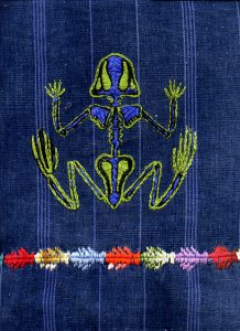 Frog embroidered on handwoven fabric